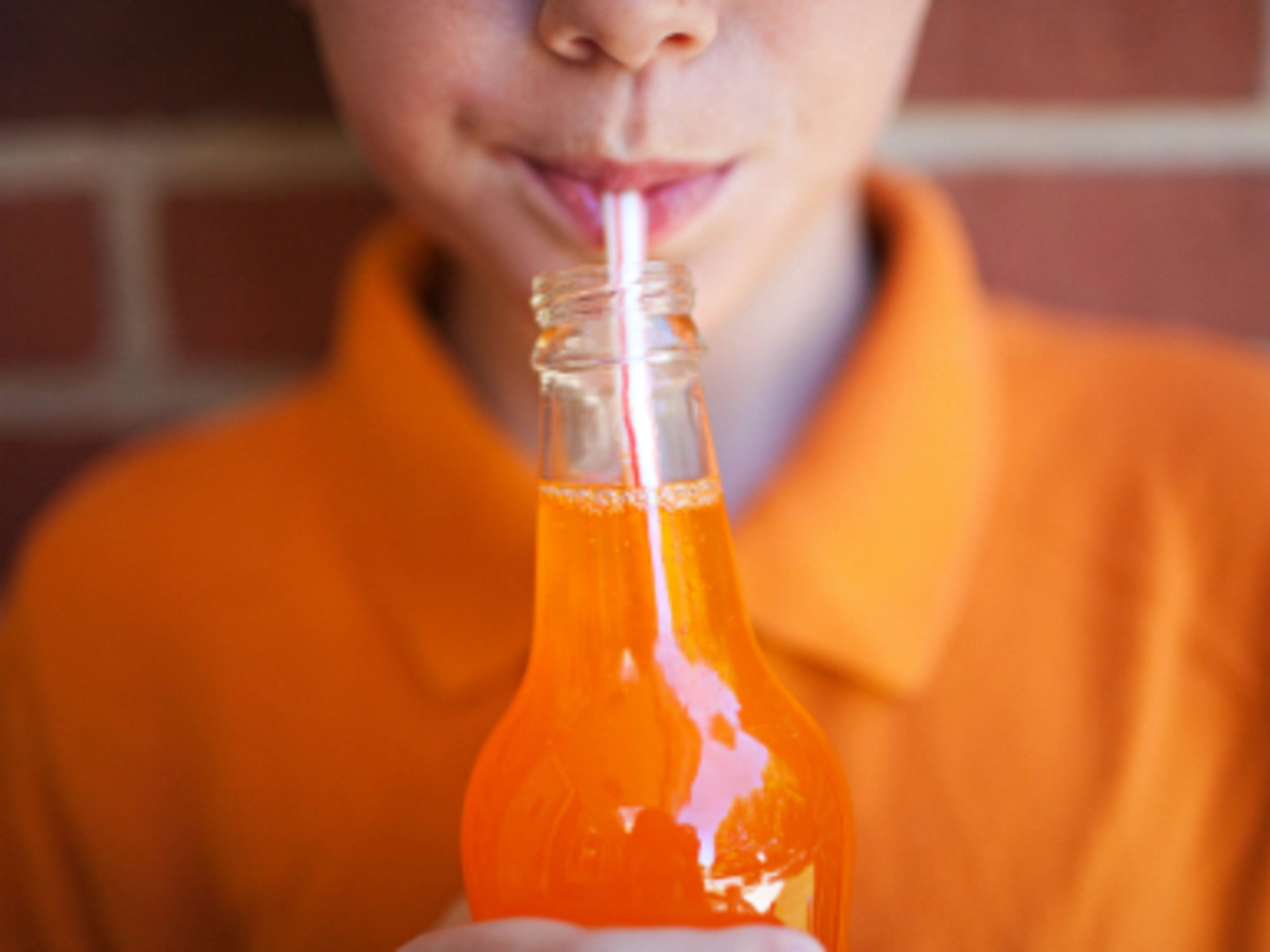 a person drinking with a straw