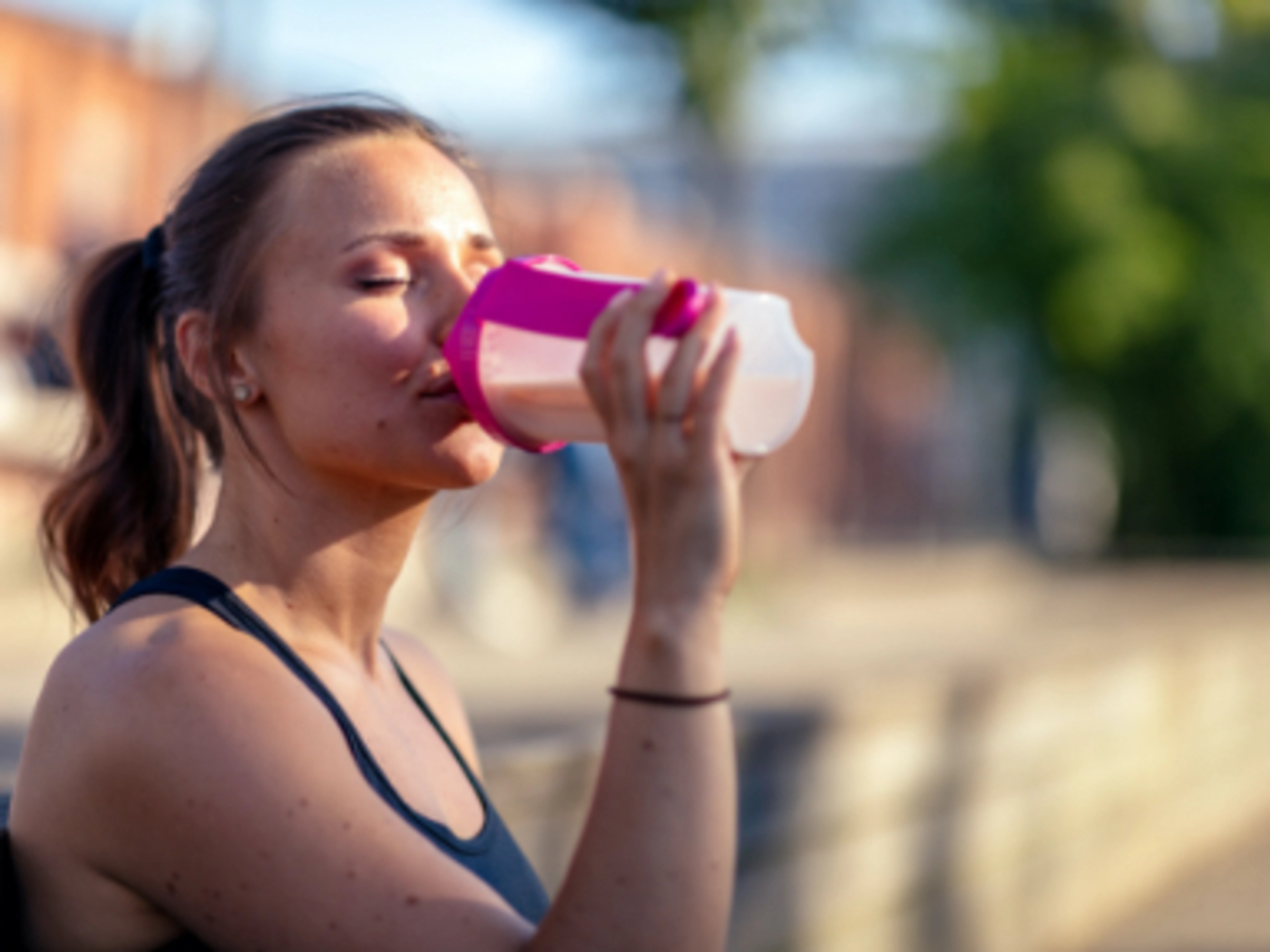 a woman drinking from a bottle