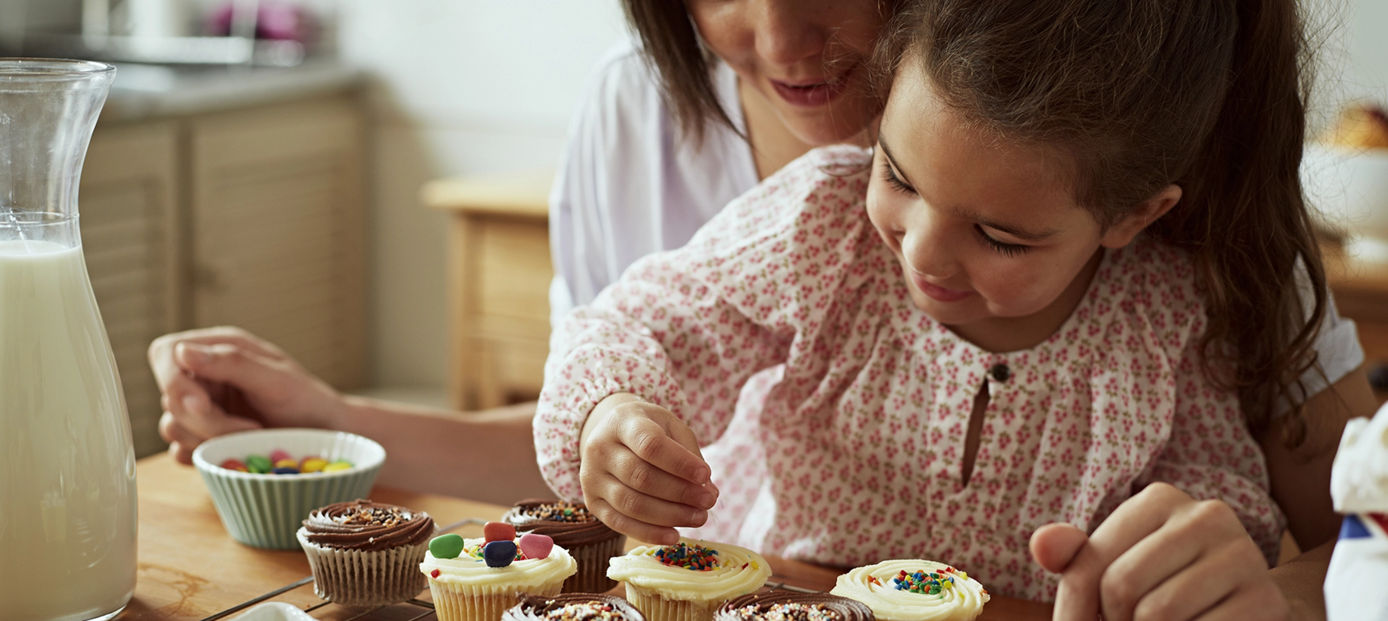 Mother and daughter baking in kitchen
