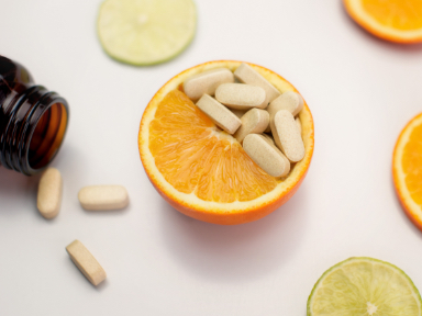an orange with supplement capsules