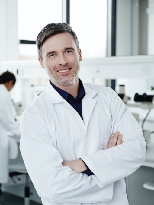 a man smiling in a laboratory
