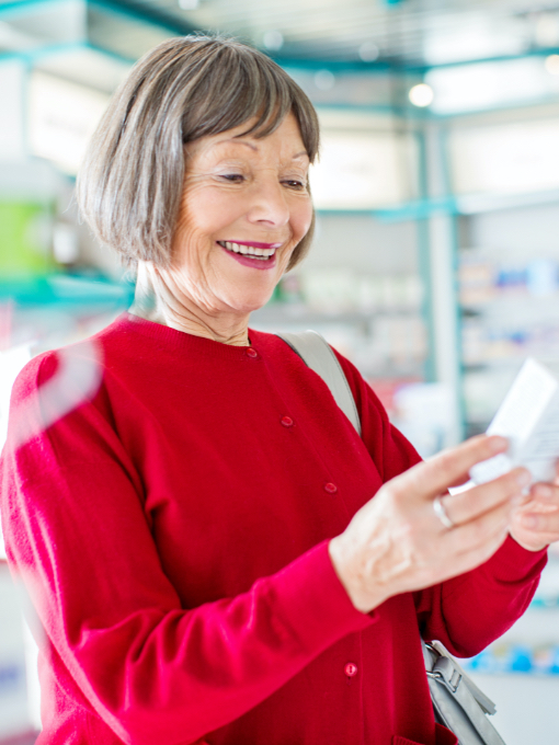 a woman holding a product and smiling