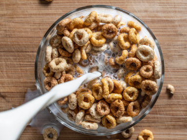 Milk pouring into a bowl of cereal