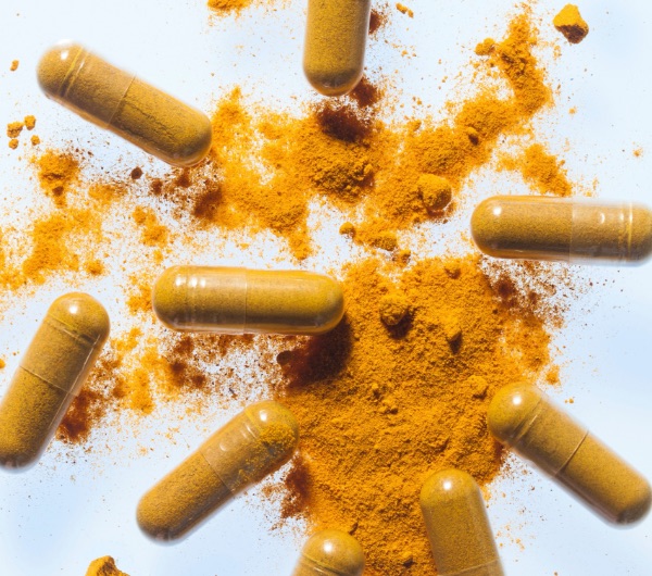 orange capsules with turmeric powder