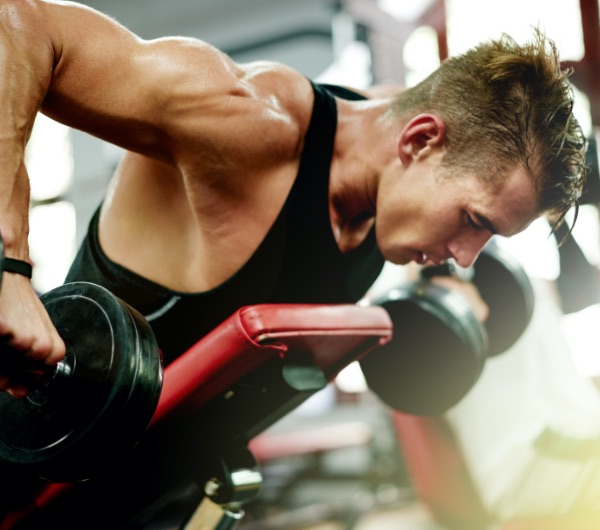 man lifting weights in a gym