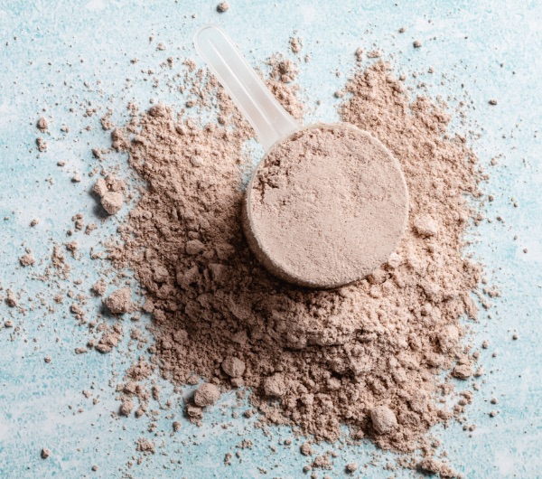 chocolate powder in a clear plastic scoop