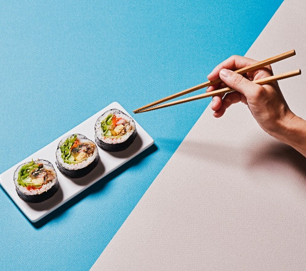 three pieces of sushi on a small white plate