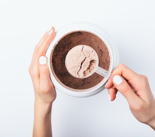 chocolate powder in a clear plastic scoop