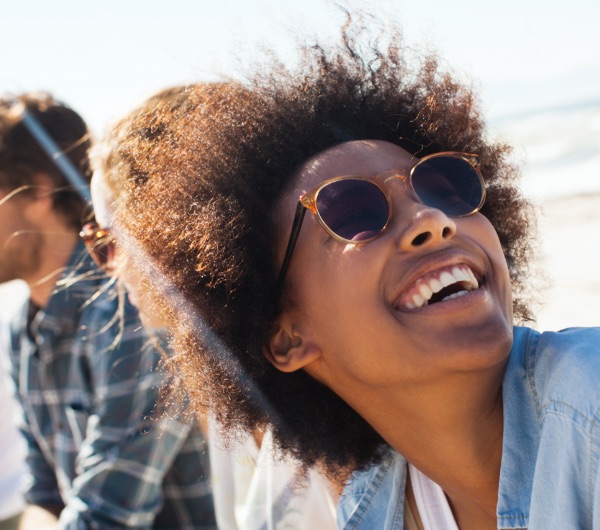 woman smiling and wearing sunglasses