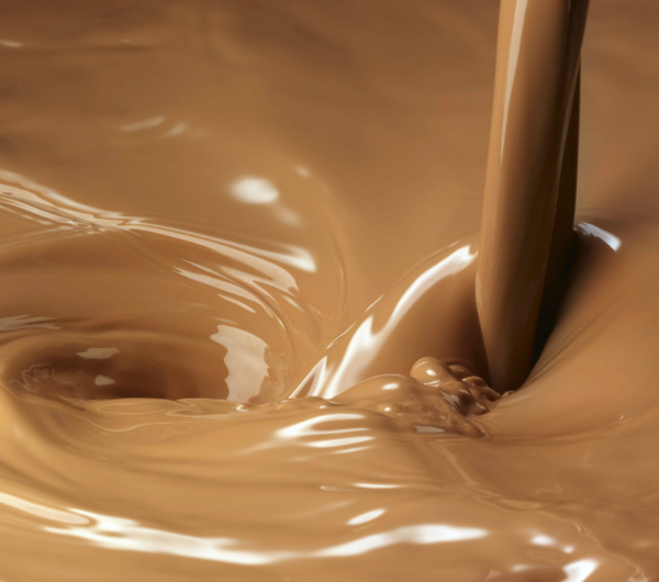 chocolate liquid pouring into a glass