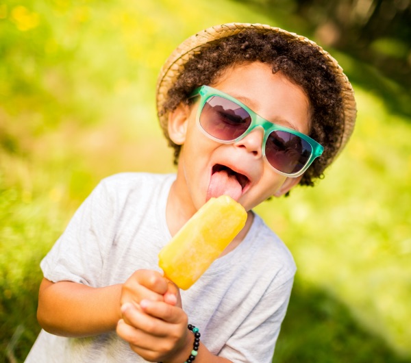 Boy enjoying a sweet lollypop on a sunny day