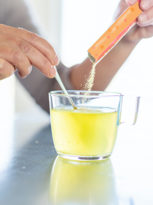 instant drink powder mixing with water in a glass mug